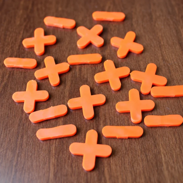Orange plus and minus tile spacers for adding and subtracting integers